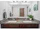 Bathroom with double vanity, granite counters, and large framed mirror at 1760 Fox Grape Loop, Lutz, FL 33558
