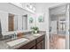 Bathroom featuring double vanity, granite counters, and a leafy green accent at 1760 Fox Grape Loop, Lutz, FL 33558