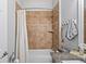 Bathroom featuring a shower over tub with tile surround at 1760 Fox Grape Loop, Lutz, FL 33558