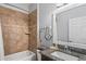 Cozy bathroom features tile shower over tub and granite vanity at 1760 Fox Grape Loop, Lutz, FL 33558