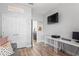 Bedroom with built-in desk area and an ensuite bathroom at 1760 Fox Grape Loop, Lutz, FL 33558