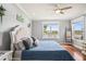 Bright bedroom with a comfortable bed, hardwood floors, and a view of the water at 1760 Fox Grape Loop, Lutz, FL 33558
