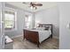 Bright bedroom featuring wood floors, large windows with blinds, and neutral paint at 1760 Fox Grape Loop, Lutz, FL 33558
