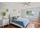 Serene bedroom featuring a plush bed, hardwood floors, and a picturesque lake view at 1760 Fox Grape Loop, Lutz, FL 33558