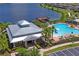 Exterior view of the community clubhouse, pool, lake and pier, perfect for gatherings and recreation at 1760 Fox Grape Loop, Lutz, FL 33558