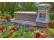 The entrance to Long Lake Ranch is beautifully landscaped with colorful flowers at 1760 Fox Grape Loop, Lutz, FL 33558