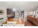 Open-concept dining area with wood table, adjacent to the kitchen and living room at 1760 Fox Grape Loop, Lutz, FL 33558