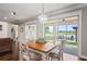 Bright dining area featuring wood table, white chairs, and sliding glass doors to the outdoor patio at 1760 Fox Grape Loop, Lutz, FL 33558