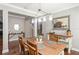 Inviting dining room with hardwood floors, modern lighting, and stylish decor at 1760 Fox Grape Loop, Lutz, FL 33558