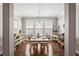Elegant dining room with hardwood floors, large windows, and a stylish wine rack at 1760 Fox Grape Loop, Lutz, FL 33558