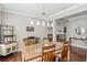 Charming dining room with a modern chandelier, wine rack, and open layout to the living area at 1760 Fox Grape Loop, Lutz, FL 33558