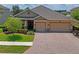 Charming home exterior with a manicured lawn and a spacious three-car garage at 1760 Fox Grape Loop, Lutz, FL 33558