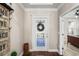 Elegant entryway with hardwood floors, decorative wreath on the glass front door, and stylish interior design at 1760 Fox Grape Loop, Lutz, FL 33558