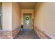Welcoming front entrance with a decorative wreath, stone accents, and a neatly paved walkway at 1760 Fox Grape Loop, Lutz, FL 33558