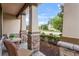 Comfortable front porch with stone detailing, complemented by cozy outdoor seating and lush landscaping at 1760 Fox Grape Loop, Lutz, FL 33558