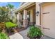 Inviting front porch with stone accents, manicured landscaping, and a charming walkway at 1760 Fox Grape Loop, Lutz, FL 33558