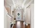 Bright and open hallway with hardwood floors, decorative lighting, and access to various rooms in the home at 1760 Fox Grape Loop, Lutz, FL 33558
