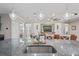 Open-concept kitchen with granite countertops, pendant lighting, and connection to the living area at 1760 Fox Grape Loop, Lutz, FL 33558