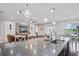 Modern kitchen with a large island, open to a comfortable living area and patio views at 1760 Fox Grape Loop, Lutz, FL 33558