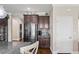 Kitchen area featuring a stainless steel refrigerator, dark wood cabinets, and tiled backsplash at 1760 Fox Grape Loop, Lutz, FL 33558