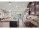 Spacious kitchen featuring granite countertops, ample storage, and an open layout with patio views at 1760 Fox Grape Loop, Lutz, FL 33558