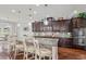 Modern kitchen featuring dark wood cabinetry, granite countertops, and stainless steel appliances at 1760 Fox Grape Loop, Lutz, FL 33558