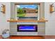 Cozy living room with a modern electric fireplace, shiplap accent wall, and a large TV screen at 1760 Fox Grape Loop, Lutz, FL 33558