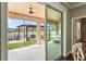 Covered patio with scenic views of the lake and pergola, perfect for relaxation and entertaining at 1760 Fox Grape Loop, Lutz, FL 33558