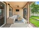 Inviting screened-in patio with a comfortable seating area and serene views of the landscaped yard at 1760 Fox Grape Loop, Lutz, FL 33558