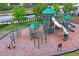 Community playground with multiple slides, climbing structures, and safety surfacing at 1760 Fox Grape Loop, Lutz, FL 33558