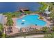 Beautiful community pool with ample seating, lakeside views, and easy access to a pier at 1760 Fox Grape Loop, Lutz, FL 33558