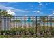 Tranquil community pool area with comfortable lounge chairs surrounded by a secure fence at 1760 Fox Grape Loop, Lutz, FL 33558