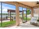 View from the screened porch showcasing the cozy outdoor lounge and backyard featuring a pergola with a firepit at 1760 Fox Grape Loop, Lutz, FL 33558