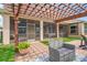 Screened in lanai with pergola, outdoor seating and a view of the backyard at 1760 Fox Grape Loop, Lutz, FL 33558