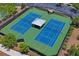 Aerial view of two community tennis courts with covered seating and surrounding landscaping at 1760 Fox Grape Loop, Lutz, FL 33558