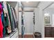 Walk-in closet that features custom shelves, drawers, hanging racks, and access to the bathroom at 1760 Fox Grape Loop, Lutz, FL 33558
