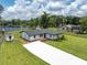 Aerial view of a home with a long driveway, and lush green lawn at 18102 Spencer Rd, Odessa, FL 33556