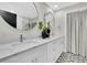 Elegant bathroom with double sinks, a modern vanity, and a walk-in glass shower for a spa-like experience at 18102 Spencer Rd, Odessa, FL 33556