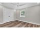 Clean bedroom with neutral walls, modern fan, wood flooring, and large double door closet at 18102 Spencer Rd, Odessa, FL 33556