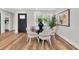 Bright dining area features a modern table set, wood floors, and stylish decor for cozy meals and gatherings at 18102 Spencer Rd, Odessa, FL 33556