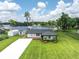 Charming lakeside home features manicured lawn, updated roof, and picturesque water views at 18102 Spencer Rd, Odessa, FL 33556
