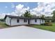 A neatly kept home featuring a pristine driveway and lush greenery at 18102 Spencer Rd, Odessa, FL 33556