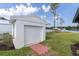 Detached garage with a red brick pathway and lake views at 18102 Spencer Rd, Odessa, FL 33556