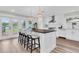 Modern kitchen features white cabinets, a large island with seating, and lake views at 18102 Spencer Rd, Odessa, FL 33556
