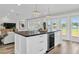 Kitchen island with a wine fridge, wooden countertop, with views of the living room and lakefront at 18102 Spencer Rd, Odessa, FL 33556