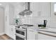 Close-up of a stylish kitchen featuring stainless steel appliances, white subway tile, and modern cabinetry at 18102 Spencer Rd, Odessa, FL 33556