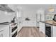 Bright kitchen features all-white cabinets, modern appliances, and a view to the kitchen island at 18102 Spencer Rd, Odessa, FL 33556