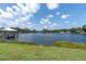 Beautiful lake view showcasing the tranquil waterfront and lush green lawn at 18102 Spencer Rd, Odessa, FL 33556