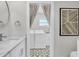 Bright laundry room with front load washer and dryer, patterned floors, and sink at 18102 Spencer Rd, Odessa, FL 33556