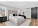 Cozy main bedroom with a comfortable bed, modern nightstands, and a view to the ensuite bathroom at 18102 Spencer Rd, Odessa, FL 33556